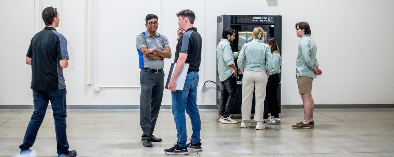 Students standing around new Gearbox 3D printer